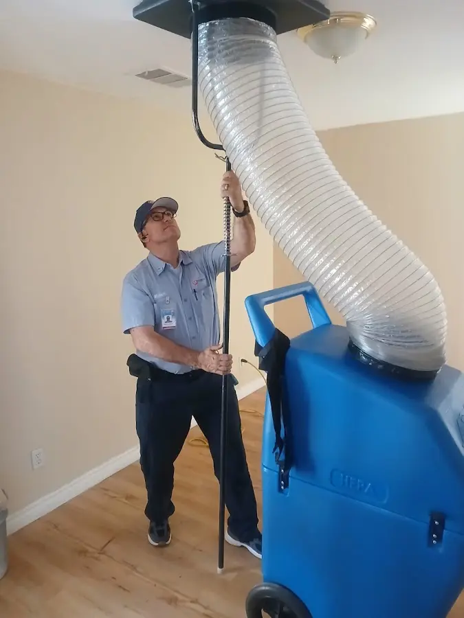 Furnace Tune-Up technician using HEPA equipment in Gonzalez
